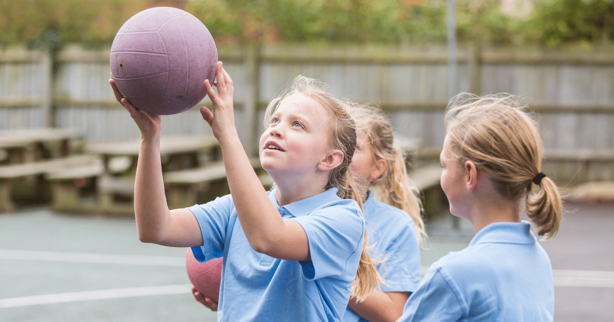 high school girls playing netball - totstoteens